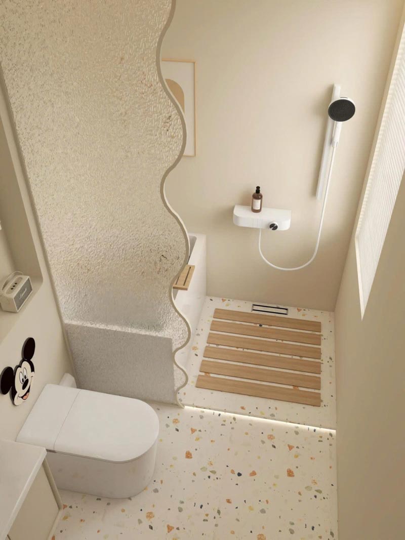 Việc sử dụng vách ngăn kính mờ dạng sóng và gạch Terrazzo là một mẹo thiết kế thông minh, giúp cải tạo nhà 18m2 bằng cách tạo ra một phòng tắm nhỏ gọn nhưng vẫn phân chia khu vực khô và ướt rõ ràng.